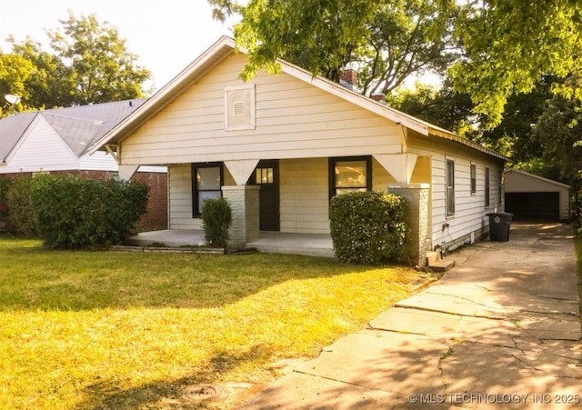 139 N College Ave, Tulsa, OK 74110 - bungalow-style house with a porch, a chimney, a front lawn, and an outbuilding