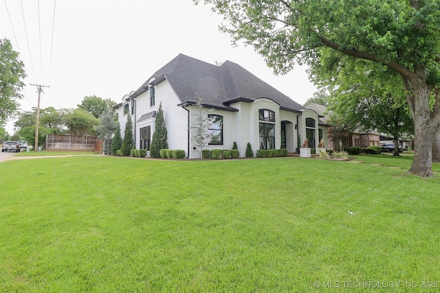 2503 S Birmingham Ave, Tulsa, OK 74114 - french country inspired facade with a front yard, a shingled roof, and stucco siding
