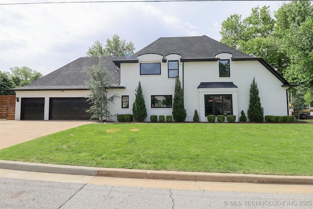 2503 S Birmingham Ave, Tulsa, OK 74114 - french country home with an attached garage, driveway, a front yard, and roof with shingles