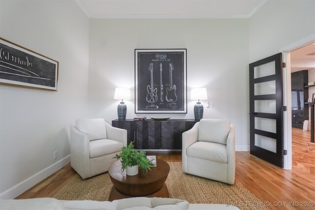 2503 S Birmingham Ave, Tulsa, OK 74114 - sitting room featuring wood finished floors, crown molding, and baseboards