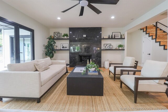 2503 S Birmingham Ave, Tulsa, OK 74114 - living area featuring ceiling fan, wood finished floors, stairs, recessed lighting, and a premium fireplace