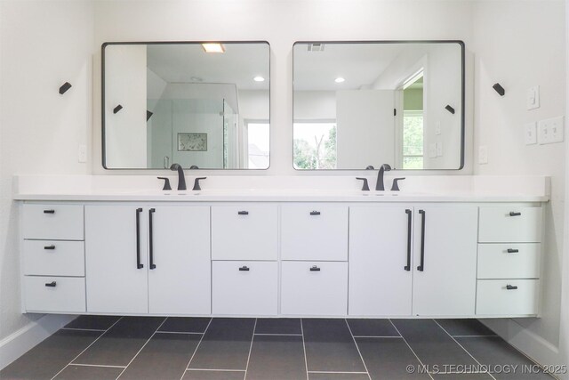 2503 S Birmingham Ave, Tulsa, OK 74114 - bathroom with double vanity, tile patterned flooring, and a stall shower