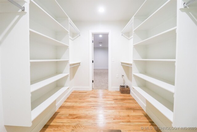 2503 S Birmingham Ave, Tulsa, OK 74114 - walk in closet featuring wood finished floors