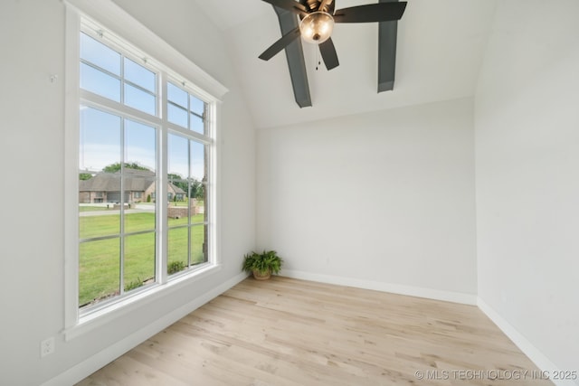 unfurnished room with wood finished floors, baseboards, a ceiling fan, and lofted ceiling