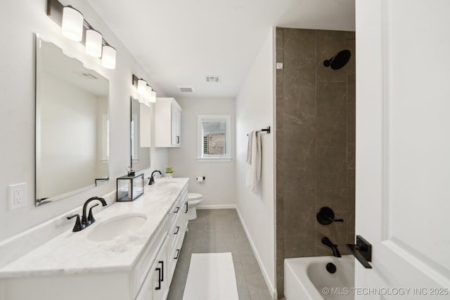full bathroom featuring double vanity, tile patterned flooring, baseboards, and toilet