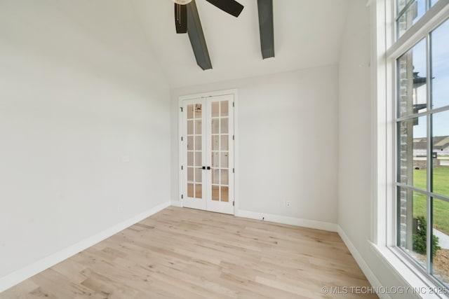 spare room with french doors, light wood-type flooring, baseboards, ceiling fan, and high vaulted ceiling