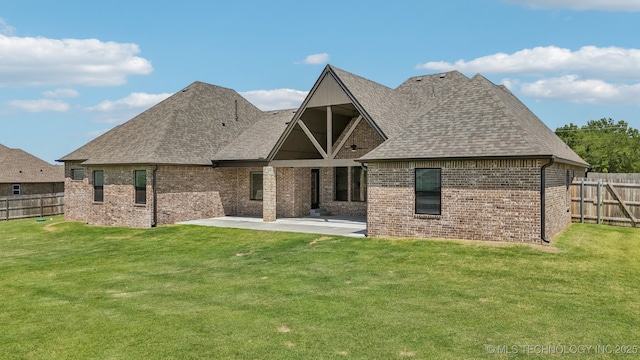 back of house with a patio area, brick siding, and a shingled roof