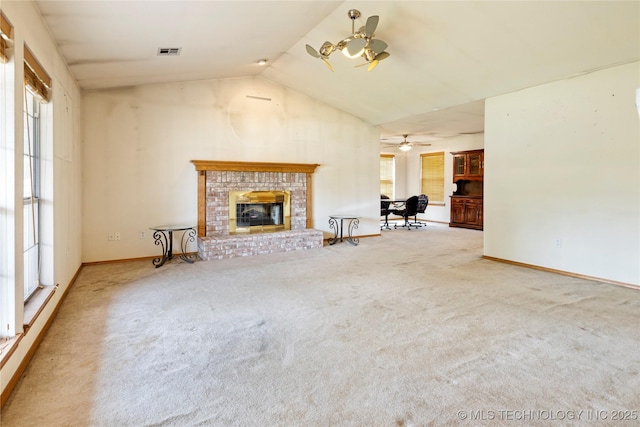 unfurnished living room with carpet, high vaulted ceiling, a fireplace, baseboards, and ceiling fan