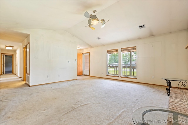 unfurnished room featuring lofted ceiling, a ceiling fan, carpet, and baseboards