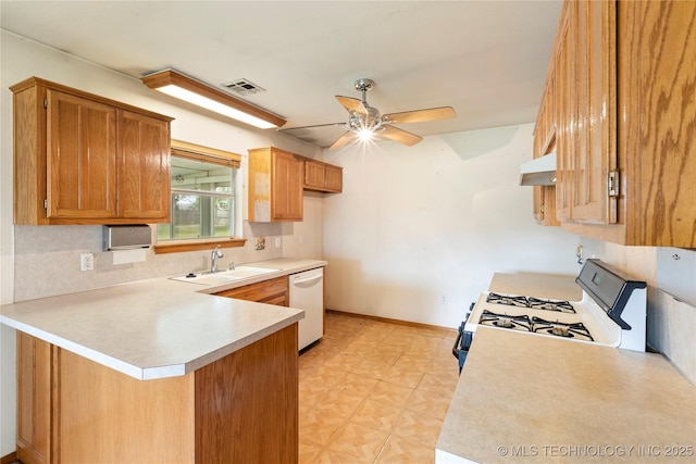 kitchen featuring dishwasher, a sink, gas range oven, a peninsula, and a ceiling fan