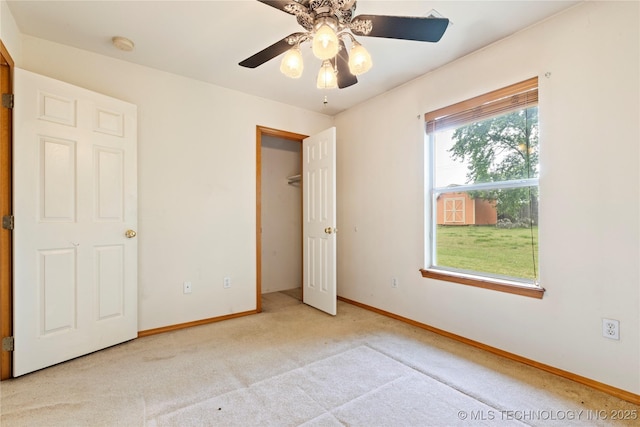 unfurnished bedroom featuring carpet flooring, baseboards, and a ceiling fan