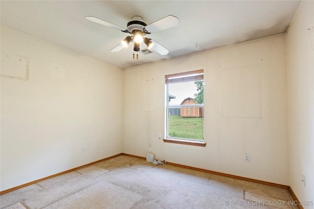 unfurnished room with baseboards, light colored carpet, and a ceiling fan