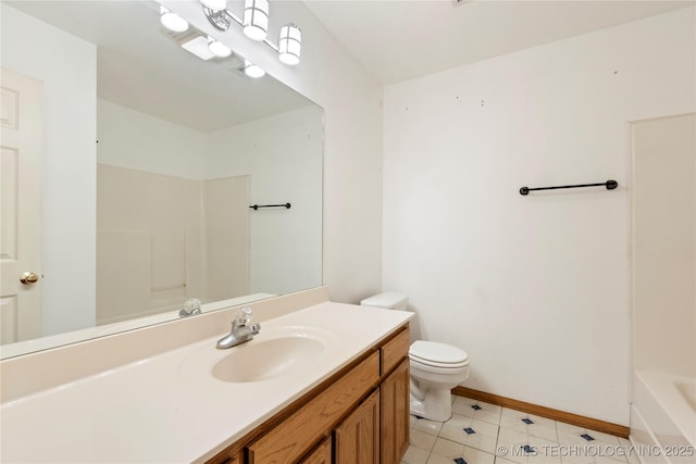 full bath with toilet, vanity, baseboards, tile patterned floors, and a tub