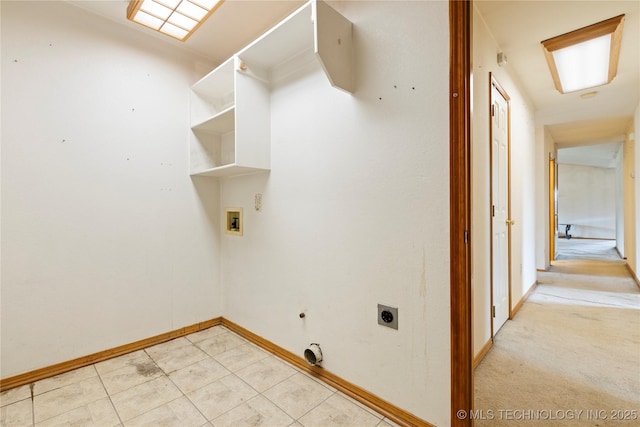 washroom with electric dryer hookup, washer hookup, baseboards, and light tile patterned floors