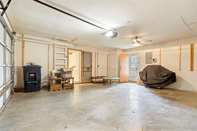 garage with electric panel, a garage door opener, and a ceiling fan