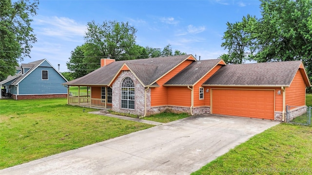 view of front facade with a garage, a front lawn, a porch, and roof with shingles