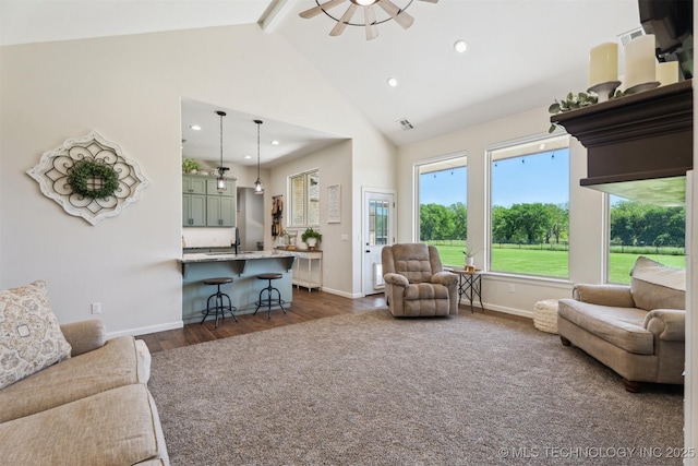 9429 Bryan Rd, Shawnee, OK 74855 - living area with dark wood finished floors, beam ceiling, high vaulted ceiling, plenty of natural light, and baseboards