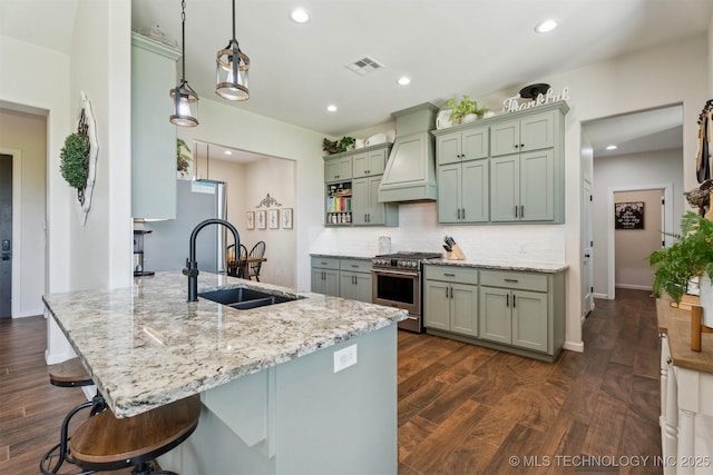 9429 Bryan Rd, Shawnee, OK 74855 - kitchen featuring high end stove, a sink, custom range hood, a peninsula, and dark wood finished floors
