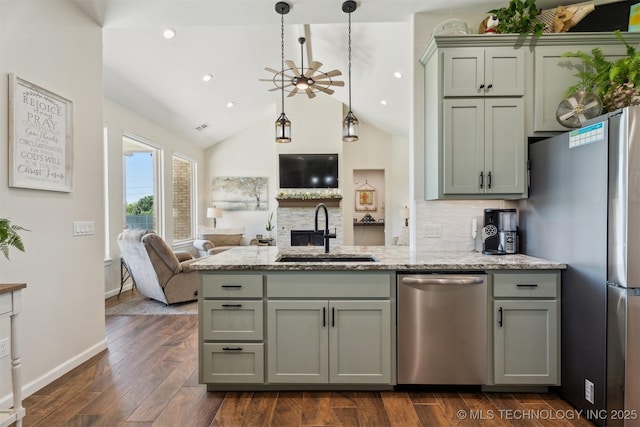 9429 Bryan Rd, Shawnee, OK 74855 - kitchen featuring stainless steel appliances, a sink, open floor plan, gray cabinets, and dark wood-type flooring