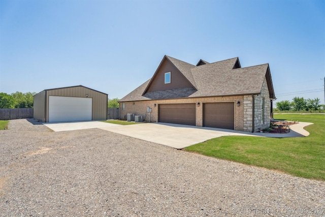 9429 Bryan Rd, Shawnee, OK 74855 - view of front of home featuring a shingled roof, brick siding, central AC unit, and an outbuilding