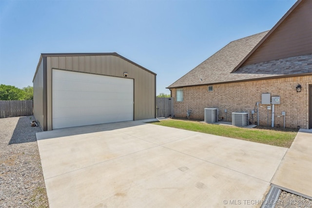 9429 Bryan Rd, Shawnee, OK 74855 - view of side of home featuring central AC unit, brick siding, an outdoor structure, and a garage