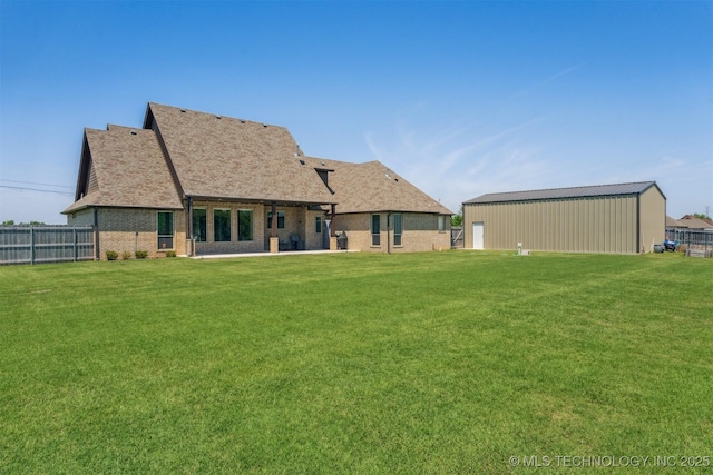 9429 Bryan Rd, Shawnee, OK 74855 - back of property featuring brick siding, a pole building, an outdoor structure, and a shingled roof