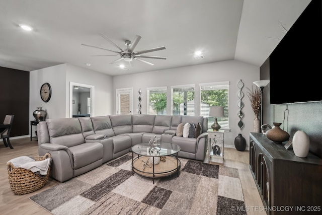 living room featuring light wood-style floors, a ceiling fan, recessed lighting, baseboards, and lofted ceiling