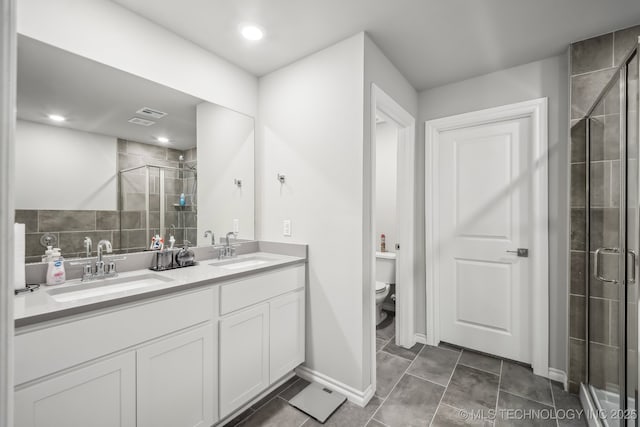 full bathroom with a stall shower, toilet, double vanity, and tile patterned floors