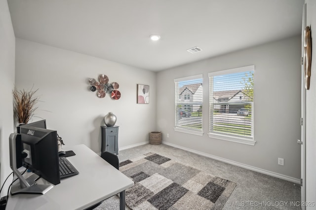 carpeted office space featuring baseboards