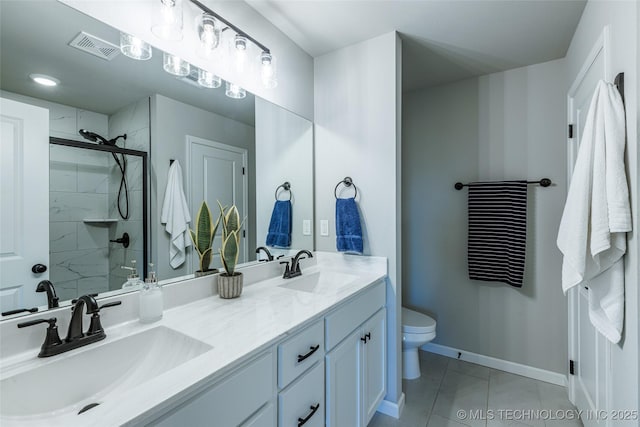 15922 E 75th Pl N, Owasso, OK 74055 - bathroom featuring a tile shower, toilet, baseboards, tile patterned floors, and double vanity