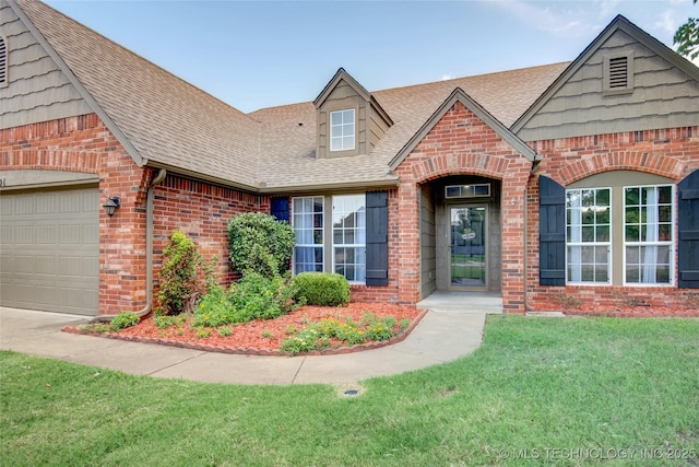 1901 N 8th St, Broken Arrow, OK 74012 - view of front facade with brick siding, a shingled roof, a front yard, and an attached garage
