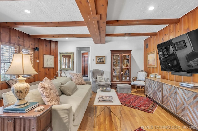 2815 S Woodward Blvd, Tulsa, OK 74114 - living room with wood finished floors, beamed ceiling, wooden walls, a textured ceiling, and recessed lighting