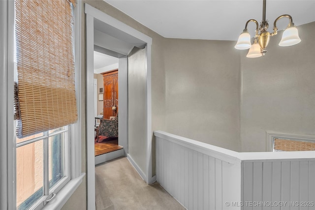 2815 S Woodward Blvd, Tulsa, OK 74114 - corridor featuring light colored carpet, a chandelier, and baseboards