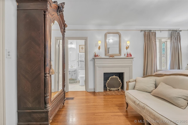 2815 S Woodward Blvd, Tulsa, OK 74114 - living area featuring light wood-type flooring and a fireplace