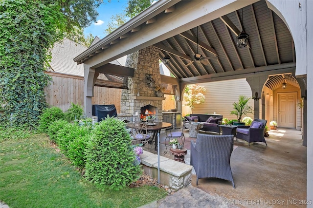 2815 S Woodward Blvd, Tulsa, OK 74114 - view of patio / terrace featuring a gazebo, ceiling fan, an outdoor living space with a fireplace, and fence