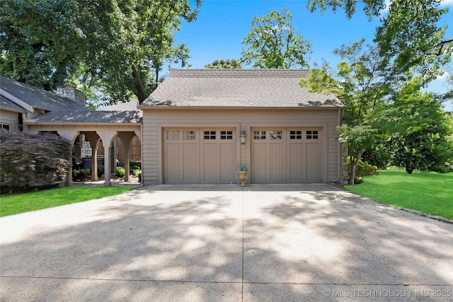 2815 S Woodward Blvd, Tulsa, OK 74114 - view of front facade featuring a front yard, an outdoor structure, a shingled roof, and a garage