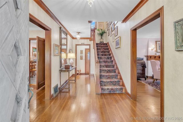 2815 S Woodward Blvd, Tulsa, OK 74114 - foyer with light wood-style flooring, stairway, ornamental molding, and baseboards