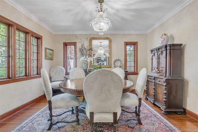 2815 S Woodward Blvd, Tulsa, OK 74114 - dining space featuring healthy amount of natural light, wood finished floors, a chandelier, and crown molding