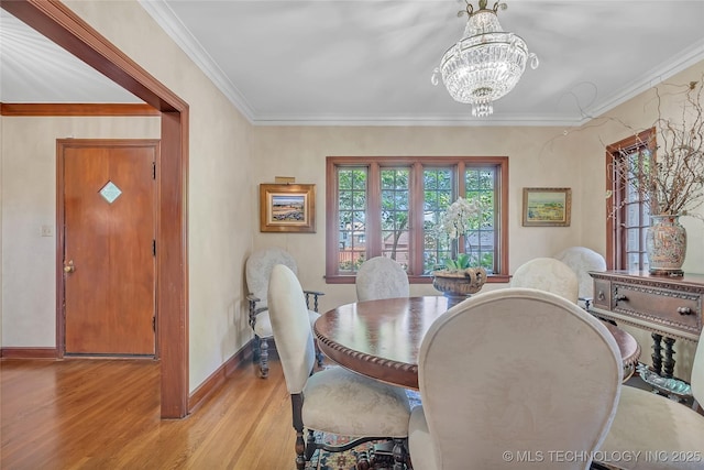 2815 S Woodward Blvd, Tulsa, OK 74114 - dining space with light wood-style floors, a chandelier, baseboards, and crown molding