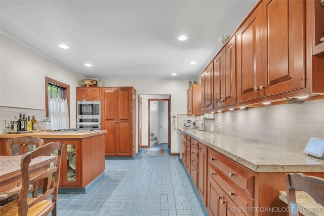 2815 S Woodward Blvd, Tulsa, OK 74114 - kitchen featuring tasteful backsplash, crown molding, brown cabinets, stainless steel oven, and recessed lighting