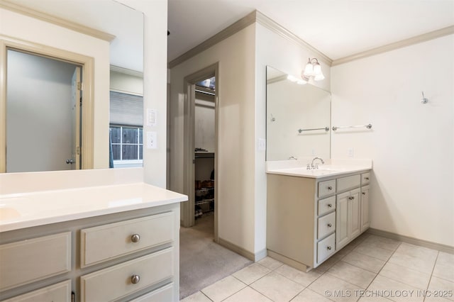 bathroom with ornamental molding, vanity, baseboards, and tile patterned floors
