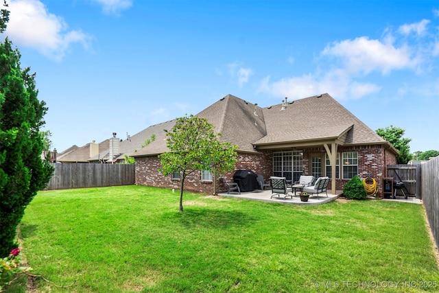 back of property with brick siding, a patio, and roof with shingles