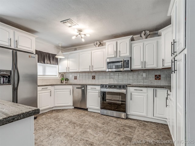 1763 S Darlington Ave, Tulsa, OK 74112 - kitchen featuring appliances with stainless steel finishes, white cabinetry, tasteful backsplash, dark stone countertops, and a textured ceiling