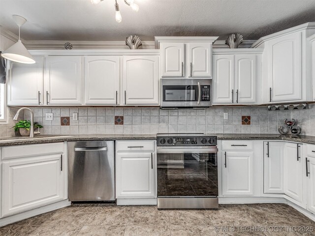 1763 S Darlington Ave, Tulsa, OK 74112 - kitchen with appliances with stainless steel finishes, white cabinetry, tasteful backsplash, a sink, and dark stone countertops