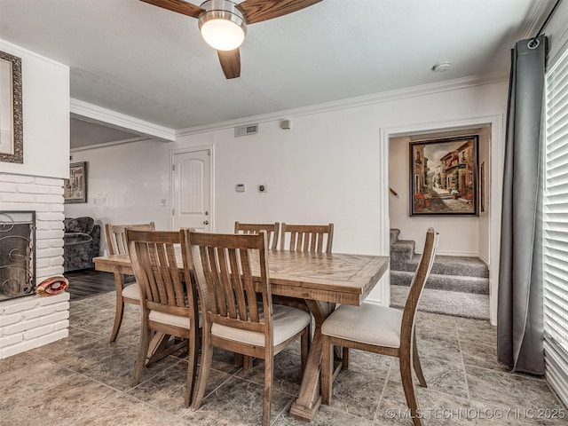 1763 S Darlington Ave, Tulsa, OK 74112 - dining space with a ceiling fan, crown molding, stairway, plenty of natural light, and a fireplace