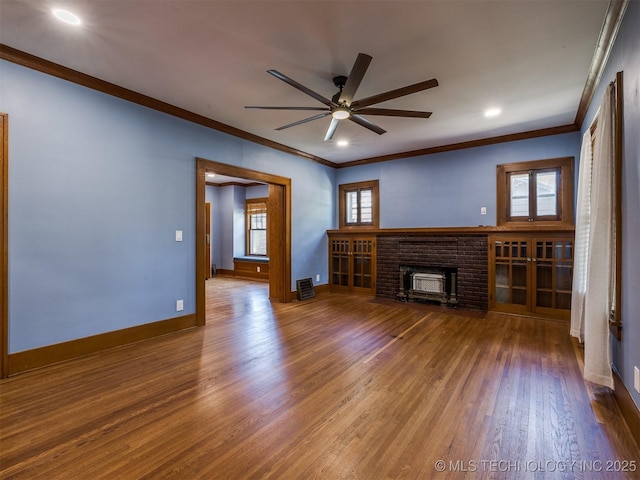 1618 S Rockford Ave, Tulsa, OK 74120 - unfurnished living room with crown molding, ceiling fan, a brick fireplace, wood finished floors, and baseboards