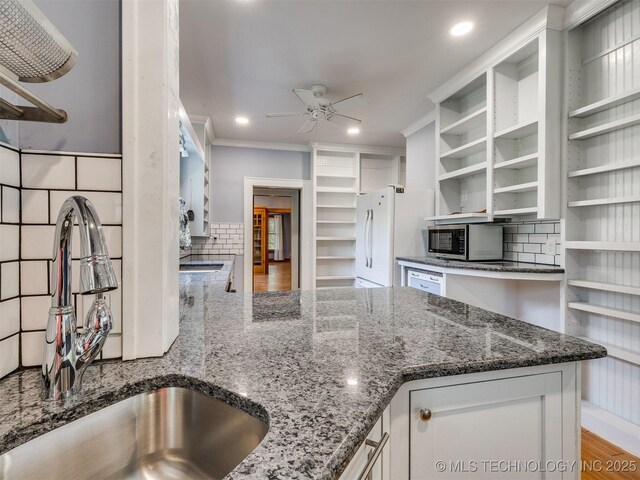 1618 S Rockford Ave, Tulsa, OK 74120 - kitchen featuring open shelves, stainless steel microwave, a sink, a ceiling fan, and freestanding refrigerator