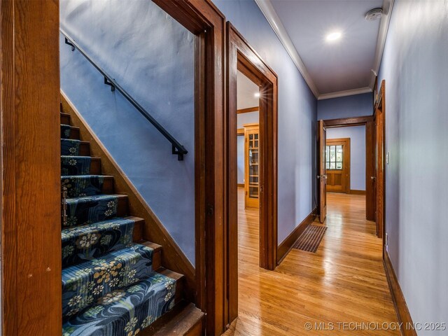 1618 S Rockford Ave, Tulsa, OK 74120 - stairs featuring wood finished floors, ornamental molding, and baseboards