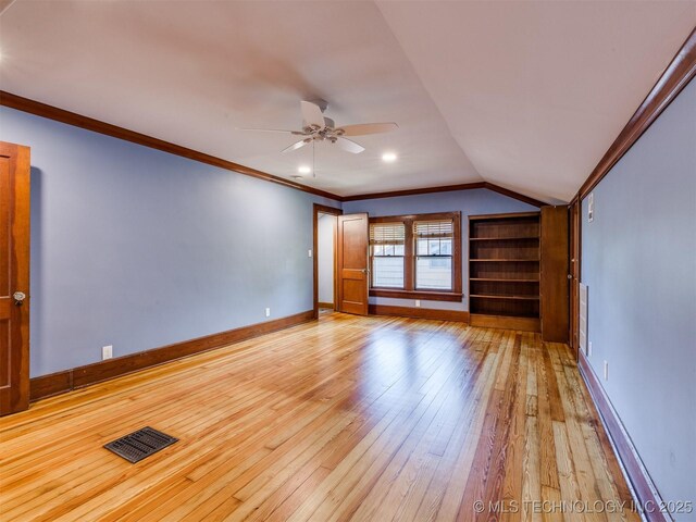1618 S Rockford Ave, Tulsa, OK 74120 - empty room with light wood finished floors, ceiling fan, vaulted ceiling, baseboards, and built in shelves