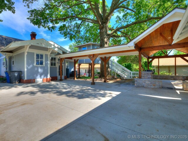 1618 S Rockford Ave, Tulsa, OK 74120 - view of patio / terrace with stairway, concrete driveway, and a carport